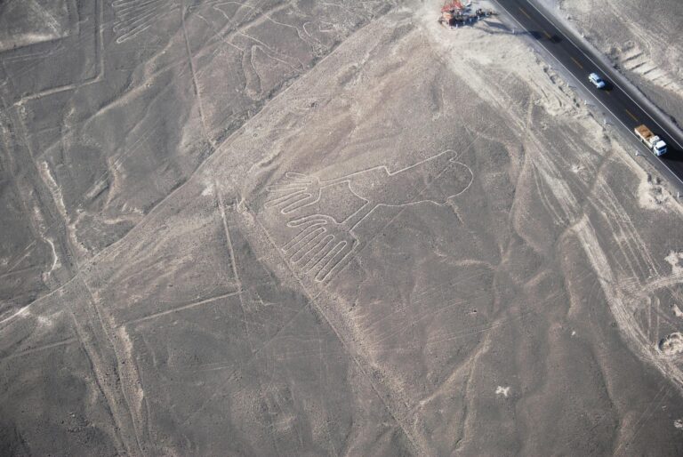 Drone shot of iconic Nazca Lines geoglyphs in Peru's desert landscape.